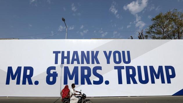 A motorcyclist passes hoardings featuring the words 'Thank You Mr. And Mrs. Trump' on a route to Motera Stadium in Ahmedabad, India. (Bloomberg) A motorcyclist passes hoardings featuring the words 'Thank You Mr. And Mrs. Trump' on a route to Motera Stadium in Ahmedabad, India. (Bloomberg)