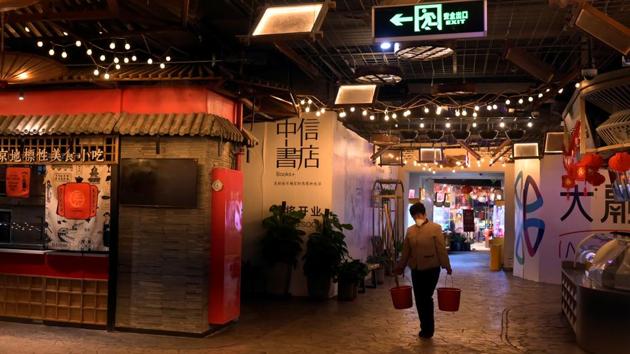 A cleaner at a food street during lunch hour in Beijing's tech hub Zhongguancun. “On a good day in the past, we could earn over 1,000 yuan ($143) a day from deliveries,” Cai told AFP. “Now, it’s just around 200 to 300 yuan a day. The impact is especially big.” He estimates losses to the company, which has more than 10 outlets in China, could be “at least a few million (yuan)” . (Tingshu Wang / REUTERS)