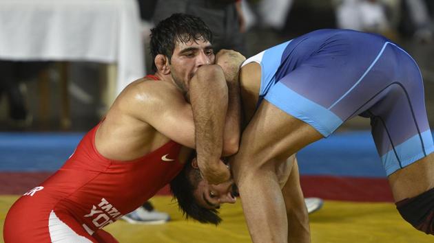 Jitender Kumar in action against Amit Dhankar during the 74kg trial final bout to qualify for the Asian Championship.(Burhaan Kinu/HT PHOTO)