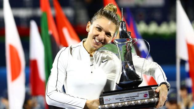 Tennis - WTA Premier 5 - Dubai Tennis Championships - Dubai Duty Free Tennis Stadium, Dubai, United Arab Emirates - February 22, 2020 Romania's Simona Halep poses with a trophy as she celebrates after winning the final against Kazakhstan's Elena Rybakina REUTERS/Ahmed Jadallah TPX IMAGES OF THE DAY (REUTERS) Tennis - WTA Premier 5 - Dubai Tennis Championships - Dubai Duty Free Tennis Stadium, Dubai, United Arab Emirates - February 22, 2020 Romania's Simona Halep poses with a trophy as she celebrates after winning the final against Kazakhstan's Elena Rybakina REUTERS/Ahmed Jadallah TPX IMAGES OF THE DAY (REUTERS)