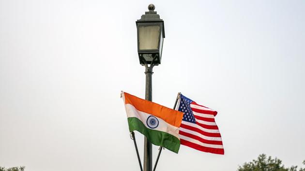 Indian and American flags fly from a lamp-post at Rajpath ahead of the arrival of U.S. President Donald Trump in New Delhi. (Bloomberg)