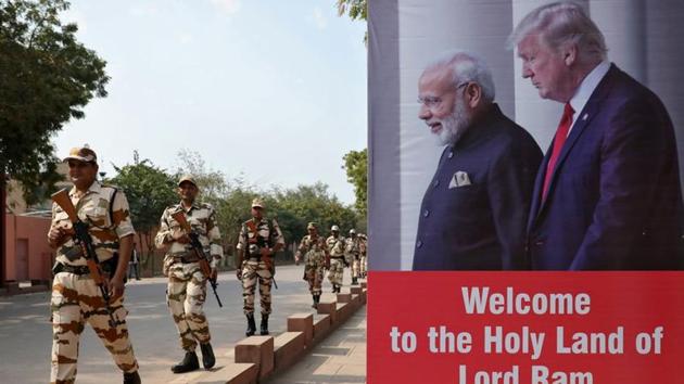 Central Industrial Security Force (CISF) personnel patrol past a hoarding near the historic Taj Mahal, where U.S. President Donald Trump and first lady Melania Trump are expected to visit, in Agra. (REUTERS)