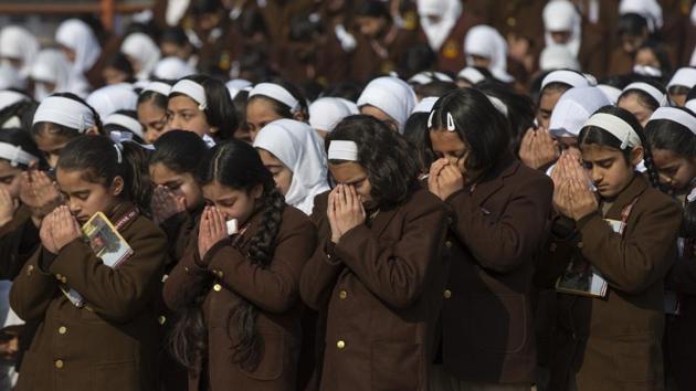 Kashmiri school children attend morning prayers in a school in Srinagar on Monday. Schools in Kashmir reopened on Monday after a gap of almost seven months.(AP)
