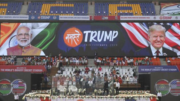 People clean the glass enclosure erected on the podium where U.S. President Donald Trump and Indian Prime Minister Narendra Modi will be seated at Sardar Patel stadium in Ahmedabad. (AP)