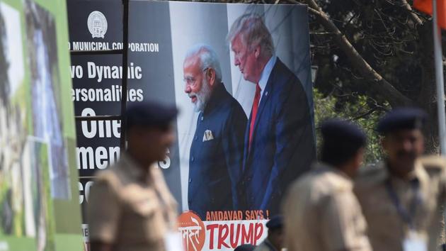 Policemen stand in front of a billboard displaying a picture of Prime Minister Narendra Modi and US President Donald Trump in Ahmedabad on February 23, 2020, ahead of Trump's arrival.(AFP)