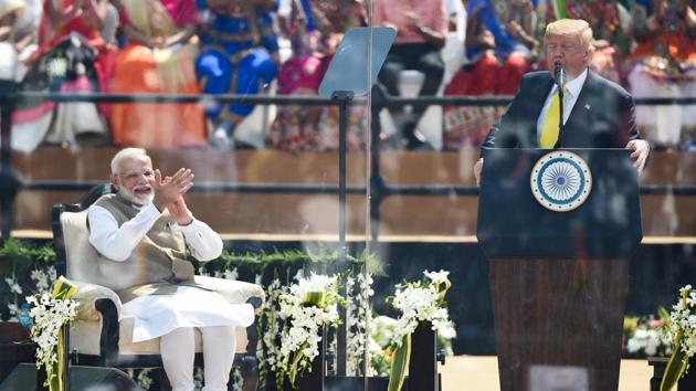 US President Donald Trump speaks as Prime Minister Narendra Modi smiles during 'Namaste Trump' event. “I have travelled 8,000 miles across the globe to convey just a message that America loves India. US respects India, will be a faithful and loyal friend, “said Trump. (Money SHARMA / AFP)