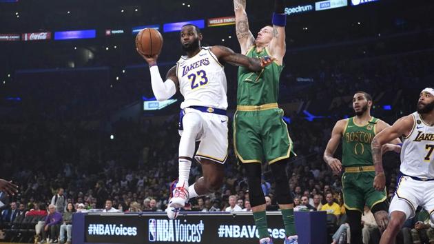Los Angeles Lakers forward LeBron James (23) passes the ball under pressure from Boston Celtics center Daniel Theis (27) in the first half at Staples Center. (USA TODAY Sports) Los Angeles Lakers forward LeBron James (23) passes the ball under pressure from Boston Celtics center Daniel Theis (27) in the first half at Staples Center. (USA TODAY Sports)