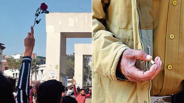 A protester holds a rose while a policeman (right) picks an empty cartridge from the site.(Photo: Raj K Raj / Hindustan Times)