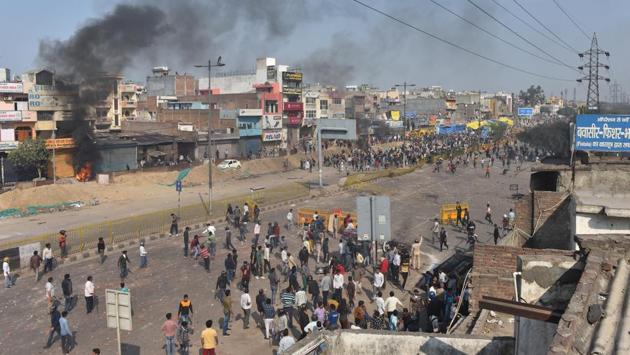 Protesters seen during a clash at Bhajanpura. Towards the end of Monday, different hospitals in the vicinity continued to receive cases of people injured in the clashes. Smoke continued to billow from shops and buildings that were set on fire. (Sanchit Khanna / HT Photo)