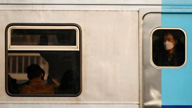 A man wearing a mask to prevent contracting the coronavirus rides on a subway in Seoul, South Korea. (Kim Hong-Ji / REUTERS)
