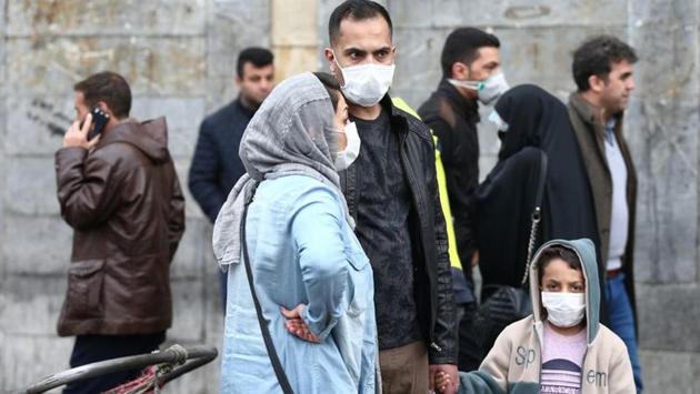 Iranian family wear protective masks to prevent contracting a coronavirus, as they stand at Grand Bazaar in Tehran, Iran. Kuwait, Bahrain, Oman, Afghanistan and Iraq reported their first new coronavirus cases, all in people who had been to Iran, where the toll was 12 dead and 61 infected. Most of the infections were in the Shi’ite Muslim holy city of Qom. (WANA / REUTERS)