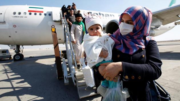 Passengers wearing protective masks disembark from a plane upon their arrival at Najaf airport, amid the new coronavirus outbreak, Iraq. Scientists around the world are scrambling to analyse the virus, but a vaccine is probably more than a year away. “Worryingly, it seems that the virus can pass from person to person without symptoms, making it extremely difficult to track, regardless of what health authorities do,” said Simon Clarke, an expert in cellular microbiology at the University of Reading in Britain. (laa al-Marjani / REUTERS)