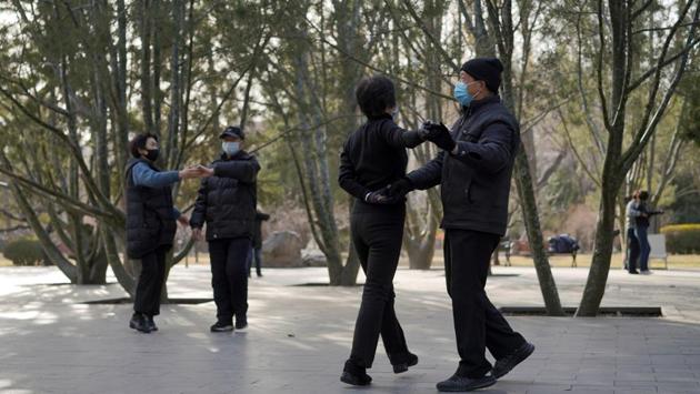 People wearing face masks dance at a park, following an outbreak of the novel coronavirus in the country, in Beijing. China has reported a total of 77,362 cases of COVID-19 and 2,618 deaths. Outside China there are now 2,074 cases in 28 countries and 23 deaths, according to WHO figures. (REUTERS)
