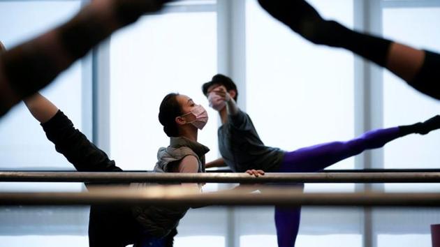 Shanghai Ballet dancers wearing masks practise in a dance studio in Shanghai, China, as the country is hit by an outbreak of the novel coronavirus. The coronavirus outbreak can still be beaten, the World Health Organization said on Monday, insisting it was premature to declare it a pandemic even though it had the potential to reach that level, reports Reuters. (Aly Song / REUTERS)