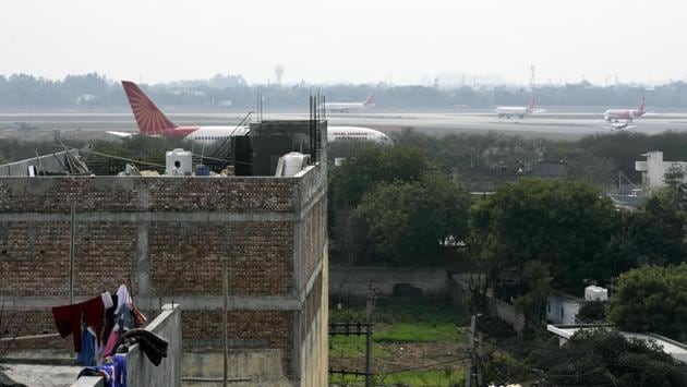 Aeroplanes are seen from a rooftop at Shahbad Mohammadpur village. An urban village of about 30,000 residents near Dwarka, about 25km from Connaught Place, has a railway station of its own, a bus terminal, is surrounded on three side by the barbed airport wall, and a Delhi Metro line runs underground—but locals say all of this, instead of easing their travel, has added to their daily travails. (Vipin Kumar / HT Photo)