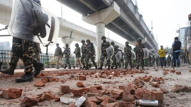 Delhi Police and forces conduct a flag march at near Babarpur. (Photos by Amal KS/HT)