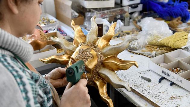 An artist works on a carnival mask at the Venice Art Mask workshop. While most of the masks are destined for the Venice market— whose carnival was suddenly cancelled this year amid a coronavirus outbreak—others are shipped off to some 40 other countries, including France, the US, UK and Australia. (Gent SHKULLAKU / AFP)
