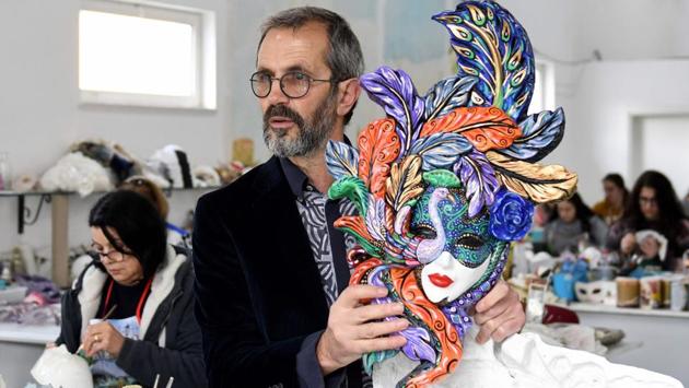 Edmond Angoni, owner of the Venice Art Mask workshop, speaks to AFP at a quiet studio in northern Albania. The studio was founded in 1997 by Edmond Angoni who worked in Italy before returning home to open his own shop. “Each mask has its own beauty, magic and mystery,” he told AFP. (Gent SHKULLAKU / AFP)
