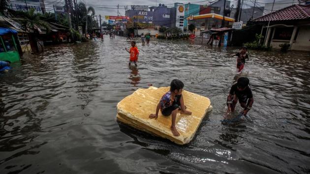 Children play in the floodwaters after heavy rains in Bekasi, near Jakarta. “We are concentrating on mitigation. We have prepared all resources to be deployed,” governor Anies Baswedan told Reuters, adding that evacuation posts had been set up with health facilities. (Antara Foto / Yulius Satria Wijaya/REUTERS)