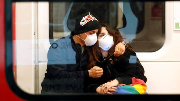 A couple wearing face masks is seen in the subway in Duomo underground station in Milan, as the country is hit by the coronavirus outbreak, Italy February 25, 2020.(REUTERS) A couple wearing face masks is seen in the subway in Duomo underground station in Milan, as the country is hit by the coronavirus outbreak, Italy February 25, 2020.(REUTERS)