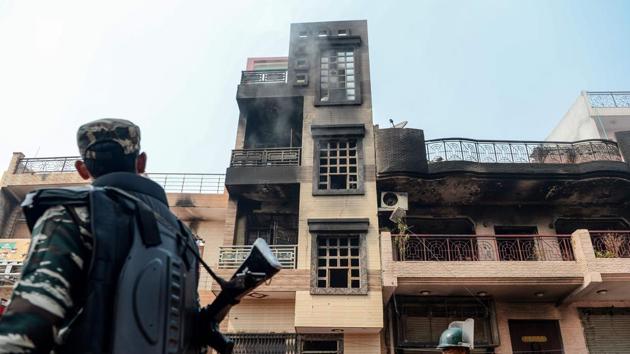 Security personnel patrol past burnt-out and damaged premises following clashes between pro- and anti CAA groups. As concerns mounted over the clashes, the government repatriated 1985 batch Indian Police Service officer SN Shrivastava from the Central Reserve Police Force (CRPF) to the Delhi Police, and posted him as the special commissioner of police—law and order. He is likely to succeed Delhi Police commissioner Amulya Patnaik. (Sajjad HUSSAIN / AFP)