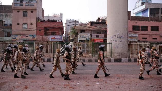 Paramilitary troops patrol in a riot affected area after clashes erupted between people demonstrating for and against a new citizenship law in New Delhi.(REUTERS)