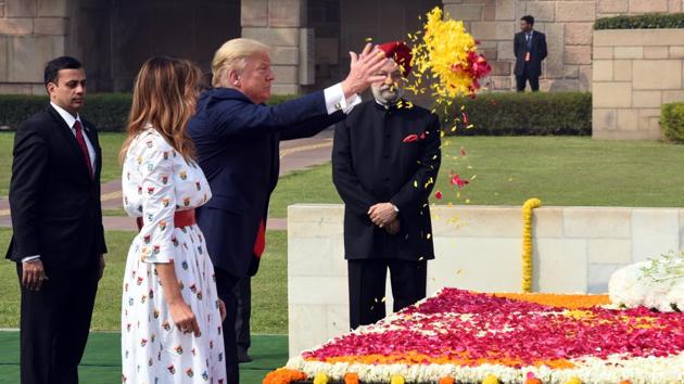 President of the United States of America Donald J. Trump and First Lady Melania Trump, accompanied by Union Minister of Civil Aviation and Housing and Urban Affairs Hardeep Singh Puri, offer a floral tribute during a wreath laying ceremony at Rajghat in New Delhi.(Sonu Mehta/HT PHOTO) President of the United States of America Donald J. Trump and First Lady Melania Trump, accompanied by Union Minister of Civil Aviation and Housing and Urban Affairs Hardeep Singh Puri, offer a floral tribute during a wreath laying ceremony at Rajghat in New Delhi.(Sonu Mehta/HT PHOTO)