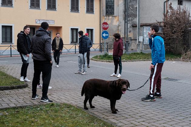 Residents of San Fiorano, one of the towns under effective quarantine due to a coronavirus outbreak, gather in a park. Police blocks were put at the entrance to the town and anyone who tries to escape the blockade faces up to three months in prison or a fine of up to 206 euros ($223). (Marzio Toniolo / REUTERS)