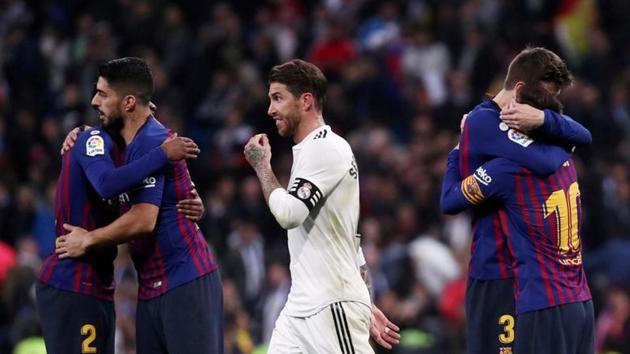 FILE PHOTO: Soccer Football - La Liga Santander - Real Madrid v FC Barcelona - Santiago Bernabeu, Madrid, Spain - March 2, 2019 FC Barcelona's Lionel Messi, Luis Suarez and Gerard Pique celebrate victory as Real Madrid's Sergio Ramos walks off REUTERS/Sergio Perez(REUTERS)