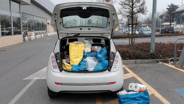 35-year-old schoolteacher Marzio Toniolo's car boot is seen full of bags of 300 euros worth of supplies from a supermarket for his family who are living in one of the towns on lockdown due to a coronavirus outbreak. “We can take walks, we can walk our dogs, we can go jogging, we can ride bikes, but the authorities have suggested that we should avoid contact with other people,” he said. (Marzio Toniolo / REUTERS)