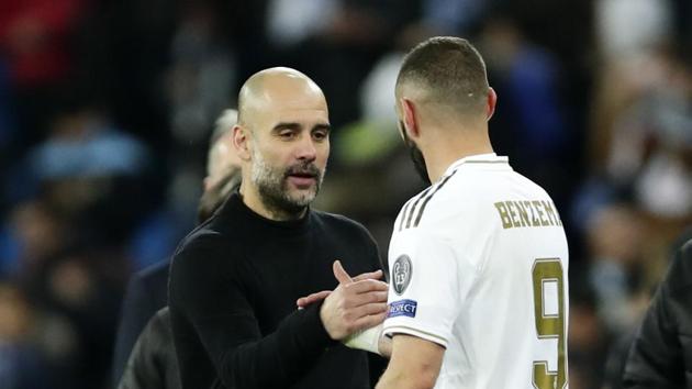 Manchester City's head coach Pep Guardiola, front left, shakes hands with Real Madrid's Karim Benzema.(AP)