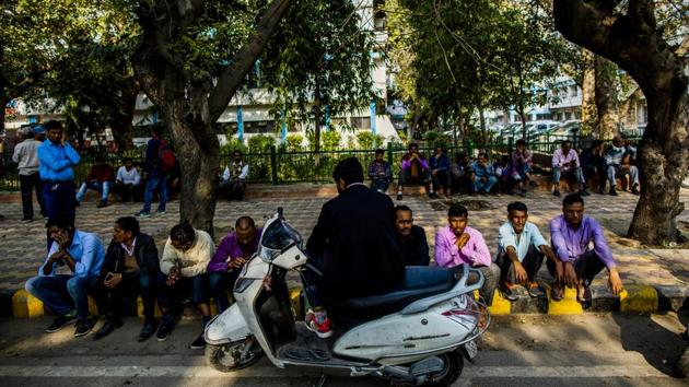 People gather outside the Guru Teg Bahadur Hospital mortuary in Delhi. Rohit Solanki, 24, said his family had been waiting for the results of an autopsy for nearly two days before it could collect the body of his older brother Rahul, who he said was shot in the neck minutes after he stepped outside to buy some milk. (Prashanth Vishwanathan / Bloomberg)