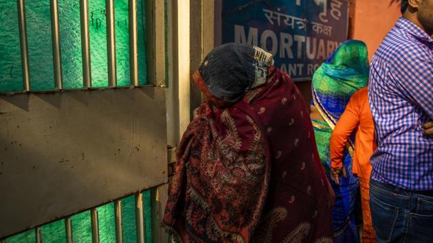 A woman peeks through the gate to the mortuary at the Guru Teg Bahadur Hospital in Delhi. On Wednesday, Modi called for calm and said police and other agencies were working “to ensure peace and harmony.” Ajit Doval, national security adviser said that the violence was under control and police were doing their jobs, Press Trust of India reported in the early morning hours on Thursday. (Prashanth Vishwanathan / Bloomberg)