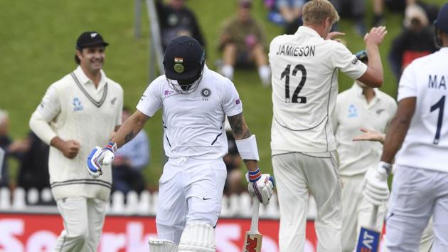 India's Virat Kohli, second left, walks from the field after he was dismissed by New Zealand's Kyle Jamieson.(AP)