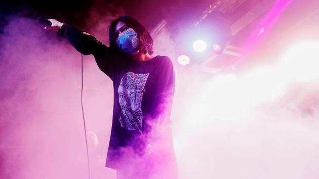 Ashley, the singer of a band called Silhungmo, wears a protective mask while performing onstage at Hidden Agenda: This Town Needs (TNN) Live House during the club's last concert as business plummets due to the fear of the coronavirus, in Hong Kong, China. (Tyrone Siu / REUTERS)