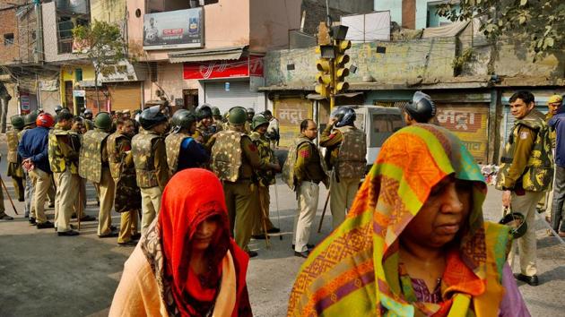 Women leave as security personnel patrol the area following communal violence over the Citizenship Amendment Act (CAA), at Yamuna Vihar, in New Delhi. (Amal KS / HT Photo) Women leave as security personnel patrol the area following communal violence over the Citizenship Amendment Act (CAA), at Yamuna Vihar, in New Delhi. (Amal KS / HT Photo)