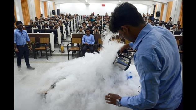 A student conducts experiments with Nitrous Oxide at Physics Department as children from various schools witness it, during Science Day at SPPU in Pune, Maharashtra. (Shankar Narayan / HT Photo) A student conducts experiments with Nitrous Oxide at Physics Department as children from various schools witness it, during Science Day at SPPU in Pune, Maharashtra. (Shankar Narayan / HT Photo)