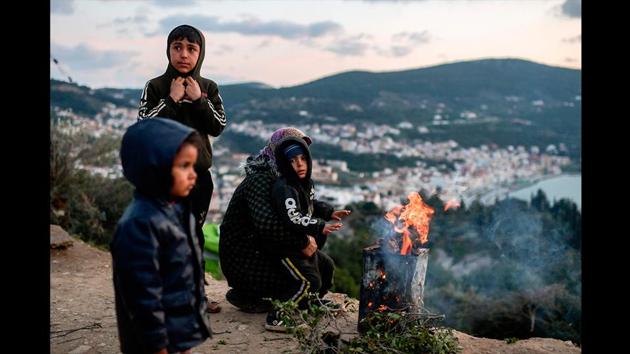A man lights a fire for his family at the unofficial camp of the Greek Aegean island of Samos. Many residents in Samos want no more refugees, no new camps and wish to be left alone as they were before the migrant crisis broke in 2015. In an effort to cope with overcrowding in Samos and other Aegean islands where some 38,000 people seeking asylum in Europe squeeze into facilities meant to take only 6,200, the government plans to replace them with "closed camps". (Aris Messinis / AFP)