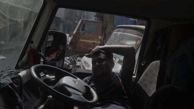 A truck driver rests inside a truck.(AP)