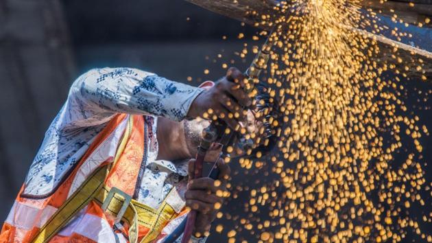 A worker welds a part of the metal scaffolding put up after the collapse of the foot over bridge at King Circle in Mumbai, Maharashtra. (Pratik Chorge / HT Photo) A worker welds a part of the metal scaffolding put up after the collapse of the foot over bridge at King Circle in Mumbai, Maharashtra. (Pratik Chorge / HT Photo)