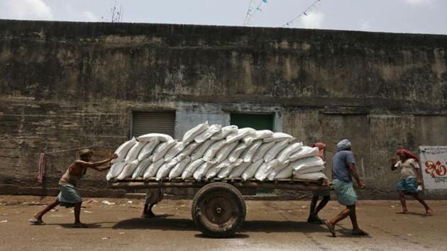 Labourers push a handcart loaded with sacks of sugar at a wholesale market in Kolkata. The latest statistics show that the current economic slowdown has been more severe than what was shown by earlier statistics.(REUTERS) Labourers push a handcart loaded with sacks of sugar at a wholesale market in Kolkata. The latest statistics show that the current economic slowdown has been more severe than what was shown by earlier statistics.(REUTERS)