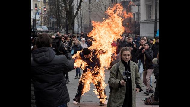 A man sets himself on fire during protest rallies in front of the presidential office in Kiev, Ukraine. The man, who called himself Oleksandr Burlakov, said subsequently that his motive was to draw the attention of the authorities to his plight, related to the ownership of the land parcel. (Ihor Behus / REUTERS)