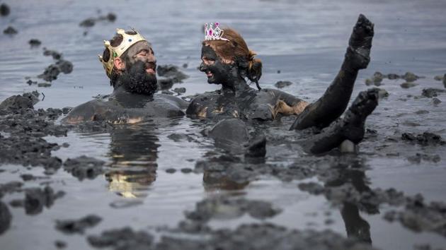 A couple of revellers enjoy the mud during the "Bloco da Lama", a mud carnival party, in Paraty, Rio de Janeiro state, Brazil. "Bloco da Lama" started in 1986 with teenagers playing with mud and became a traditional event at the historical city of Paraty. (Daniel Ramalho / AFP)