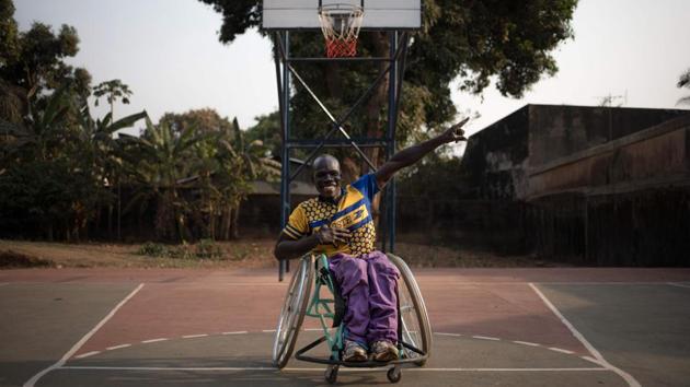 Idriss, a wheelchair basketball coach, poses on a basketball court after a game in Bangui, Central African Republic. In Bangui, a practice allows disabled people to regain dignity, thanks to prostheses and orthoses. 50% of their patients have been deteriorated because of the conflict. (Florent Vergnes / AFP)