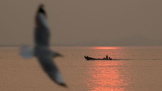 A boat during sunset as a seagull flies by, at Mawlamyine, Mon State, in Myanmar. (Sai Aung Main / AFP)