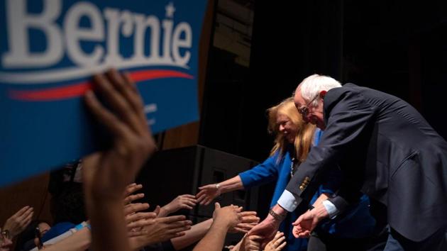 Democratic presidential hopeful Vermont Senator Bernie Sanders and his wife Jane O'Meara Sanders shake hands with supporters after Sanders addressed a rally at the Abraham Chavez Theater in El Paso, Texas. (Paul Ratje / AFP)