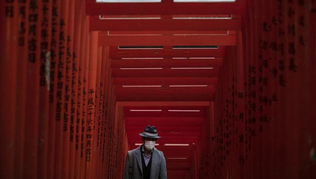 A man with a mask walk through torii gates at the Hie Shrine In Tokyo, Sunday, March 1, 2020. The coronavirus has claimed its first victim in the United States as the number of cases shot up in Iran, Italy and South Korea and the spreading outbreak shook the global economy. (AP) A man with a mask walk through torii gates at the Hie Shrine In Tokyo, Sunday, March 1, 2020. The coronavirus has claimed its first victim in the United States as the number of cases shot up in Iran, Italy and South Korea and the spreading outbreak shook the global economy. (AP)