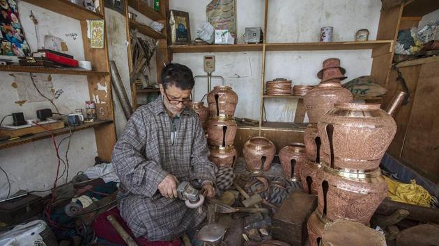 A Kashmiri coppersmith working inside a workshop in the downtown of Srinagar.(ANI) A Kashmiri coppersmith working inside a workshop in the downtown of Srinagar.(ANI)