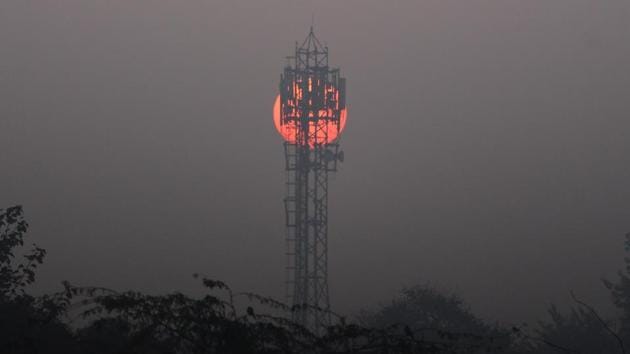 The sun rises behind a mobile communications tower on a winter cold morning, in Gurugram. (Yogendra Kumar/HT PHOTO) The sun rises behind a mobile communications tower on a winter cold morning, in Gurugram. (Yogendra Kumar/HT PHOTO)