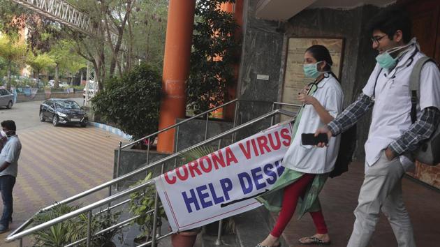 Doctors walk past the entrance of an isolation ward where people who returned from China are under observation at the Government Gandhi Hospital in Hyderabad, Monday, March 2, 2020.(AP)